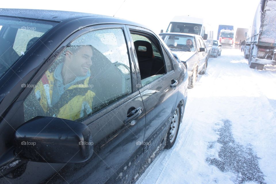 A lot of cars being stuck in the middle of the field because of huge amount of snow. 