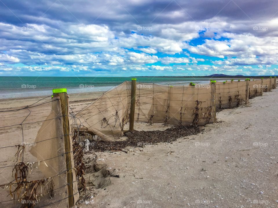 Sand screen wind barrier on beach in south Australia, perspective seashore preservation