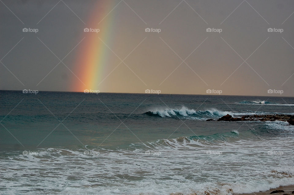 Rainbow at Poipu Beach, Kauai, Hawaii. 