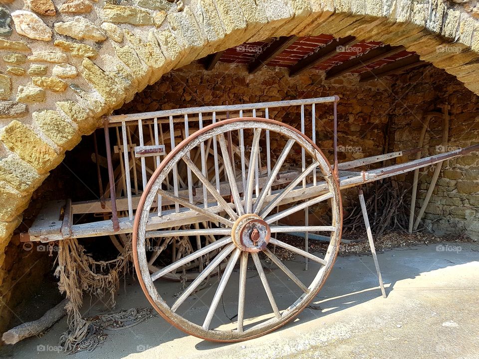 old wooden horse cart over a stone bridge