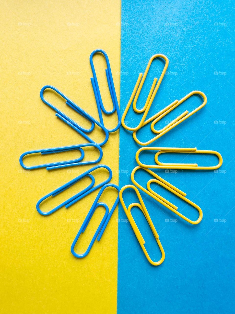 yellow and blue paper clips on colored paper