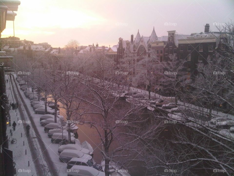 Sunrise over snowy Amsterdam canals