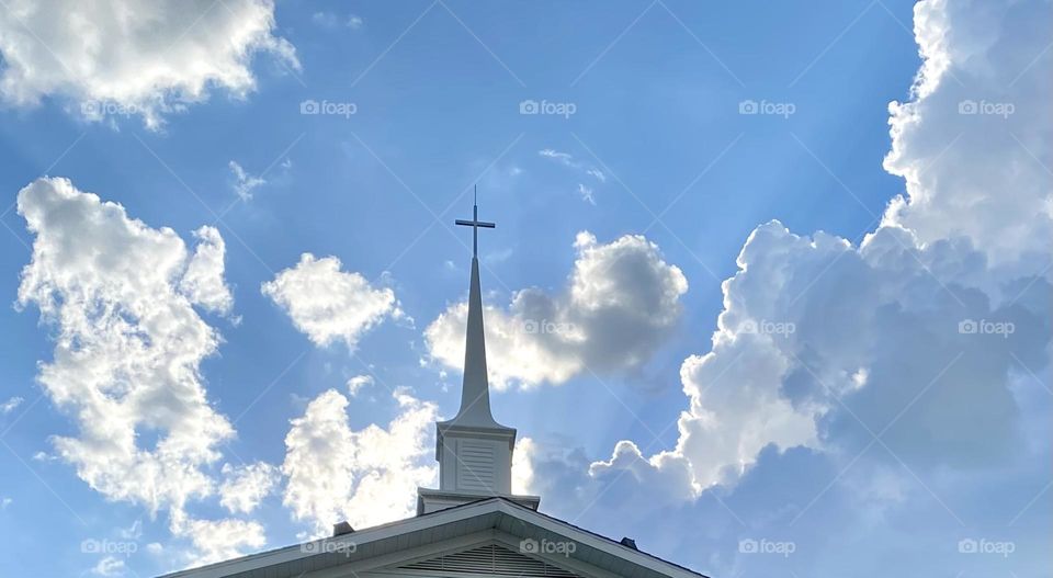 Church steeple with clouds behind it