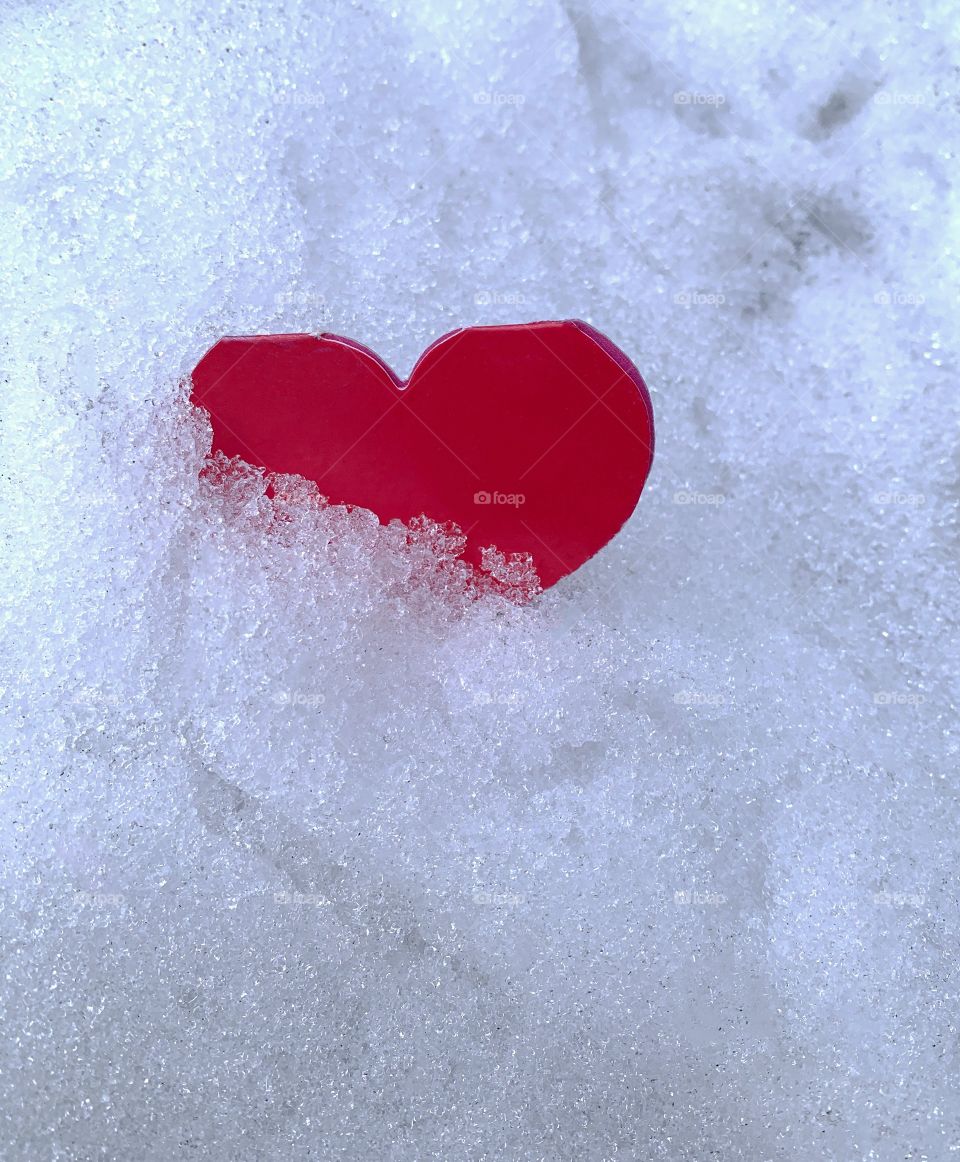 Red valentine card in snow 