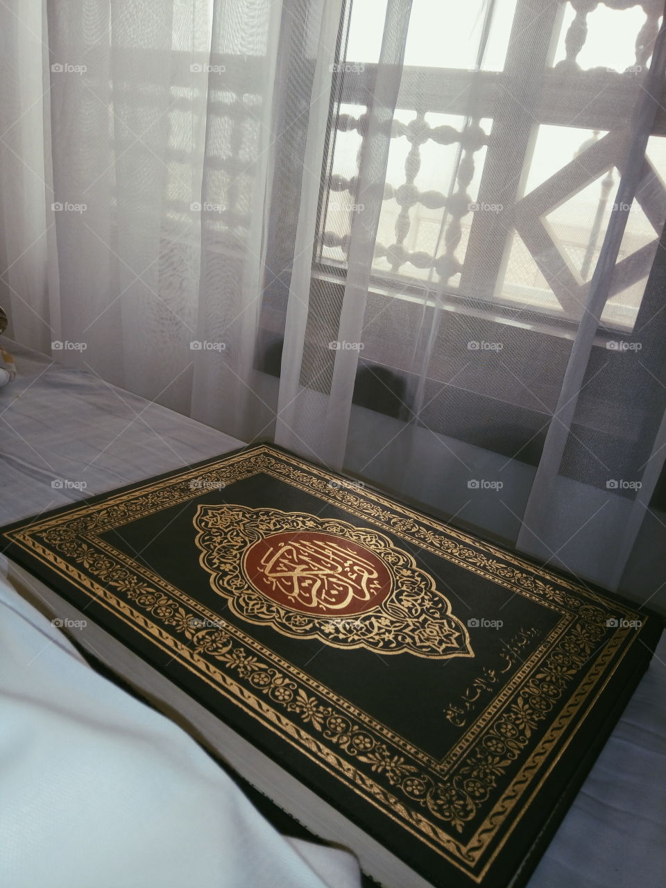 this photo shows a book of the Koran which is a sacred book for muslims. The photo was taken at the madinah of Saudi Arabia