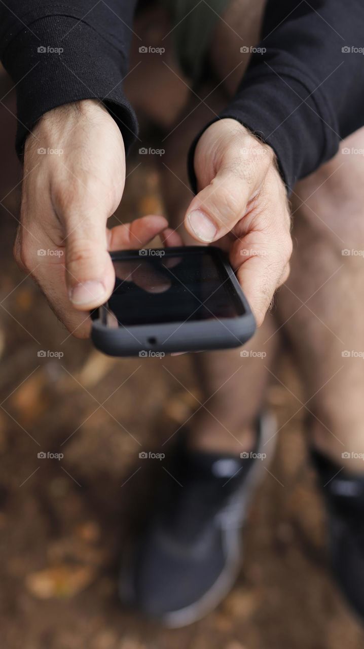 hands holding and using smartphone