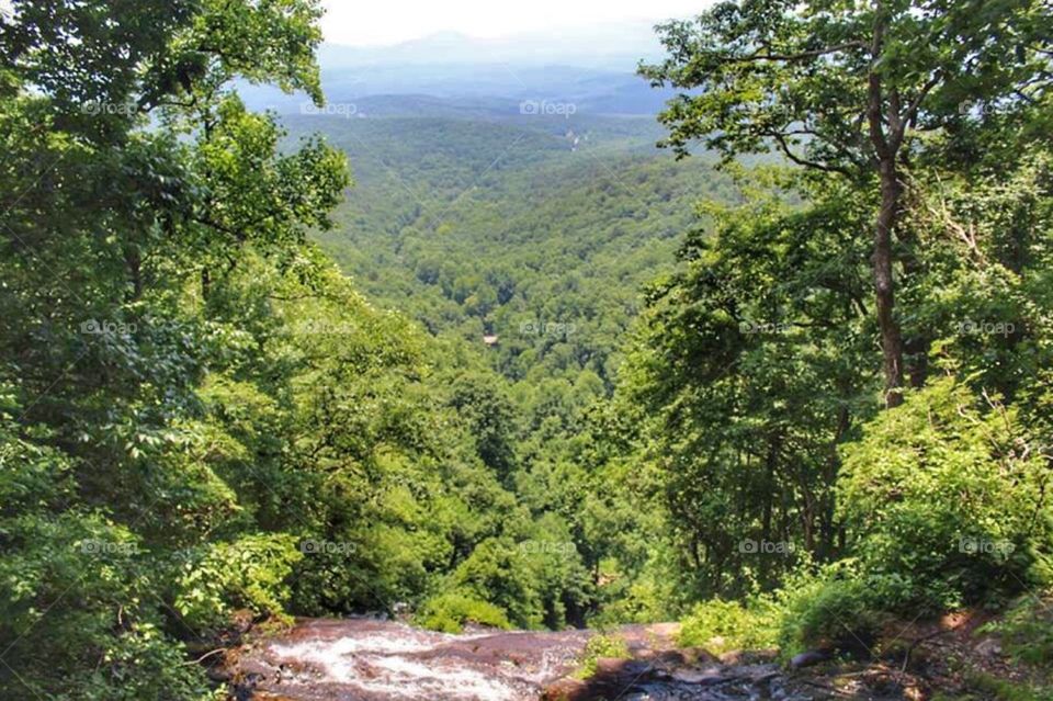 A waterfall in front of the blue ridge mountains 