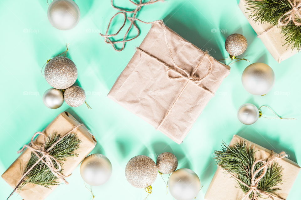 Christmas gift lying on green background. Flatlay items. Flat lay, top view, surprise, happy new year, merry, tree, packing, packed, wrapping, celebrating, holidays, winter, nobody, background 