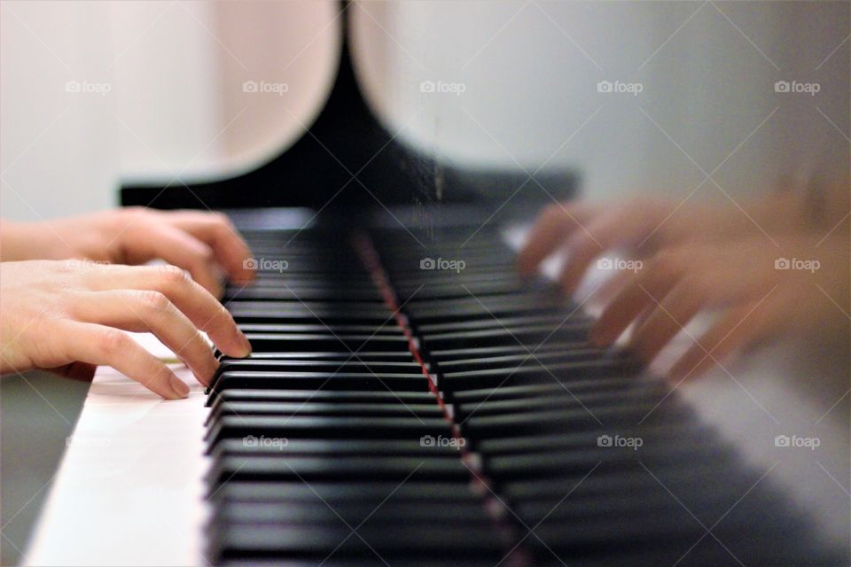 Close-up of a person playing piano