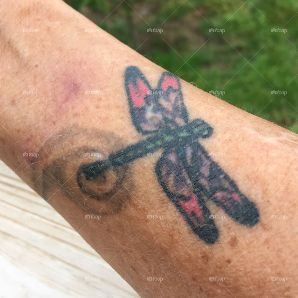 Tattoo has birthstone colors of 3 children in it.