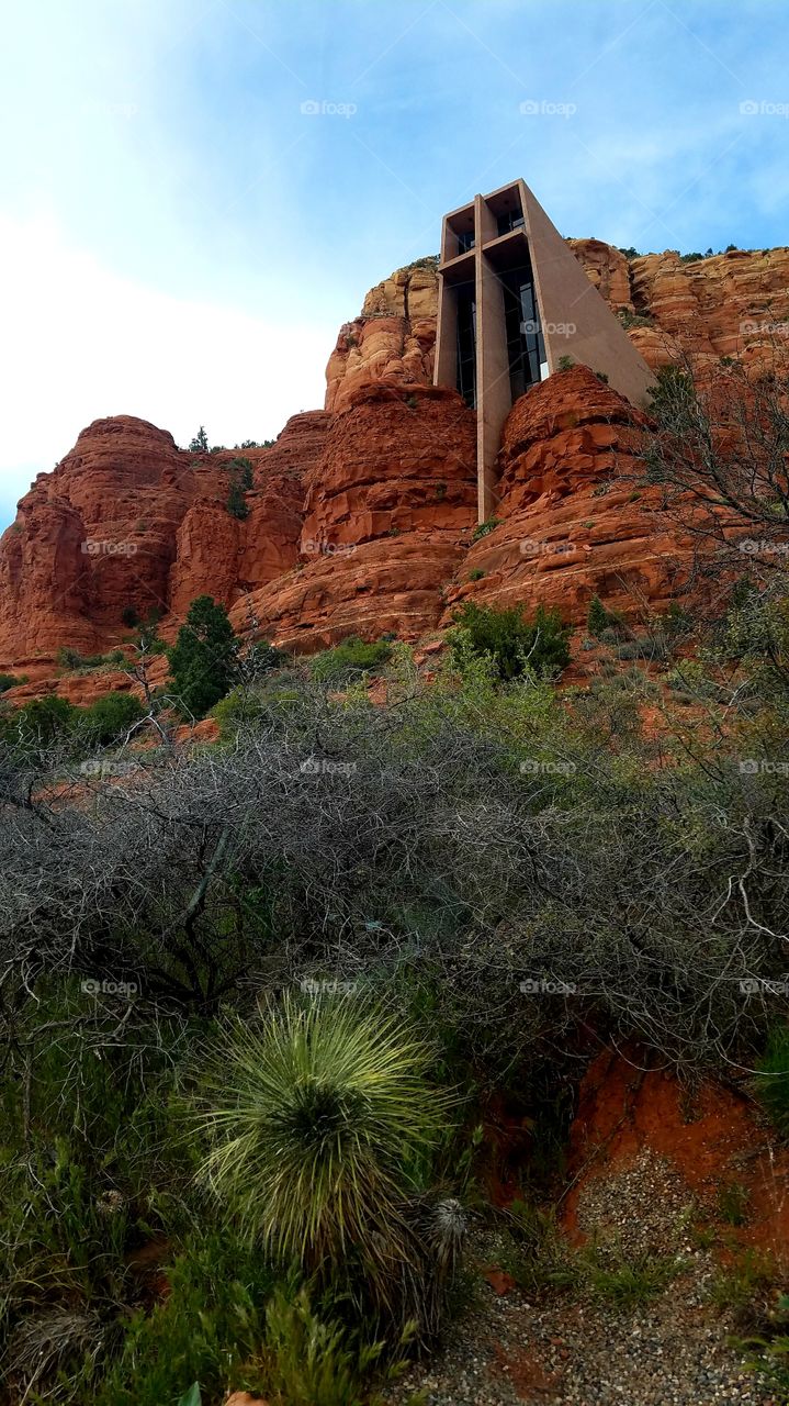 Tall church with cross built into the red rock of the desert