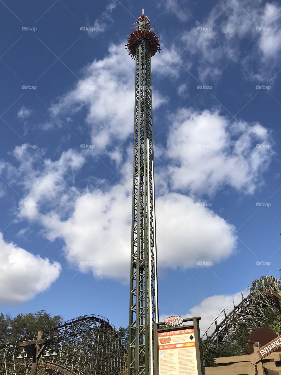 Free fall amusement park ride, terrifying, exhilarating, bright summer day