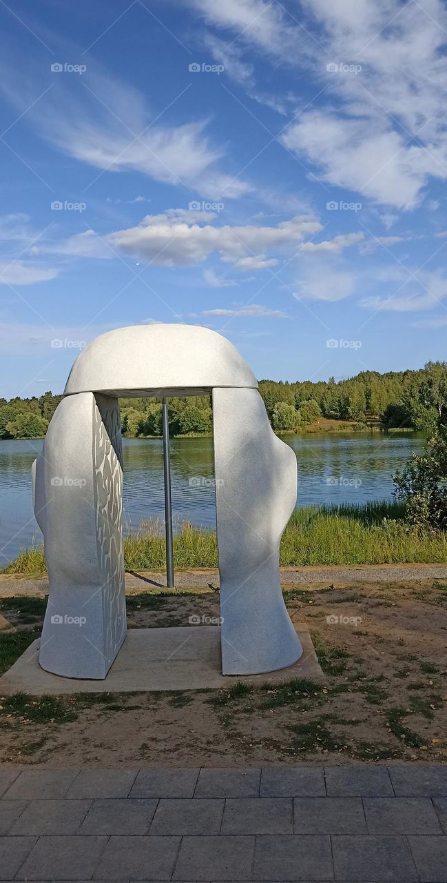 summer city lake shore view and statue