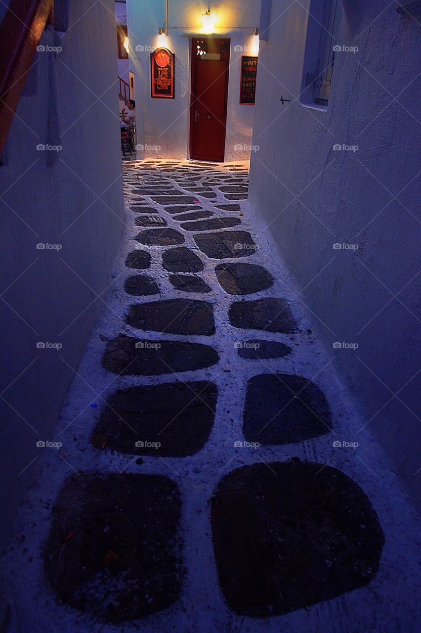 Whitewashed narrow street at night