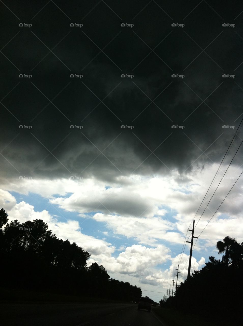 Ominous Clouds. I was riding in my friend's car in Florida when the classic afternoon summer shower chased us down.