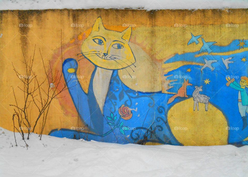 blue and yellow street art on a wall