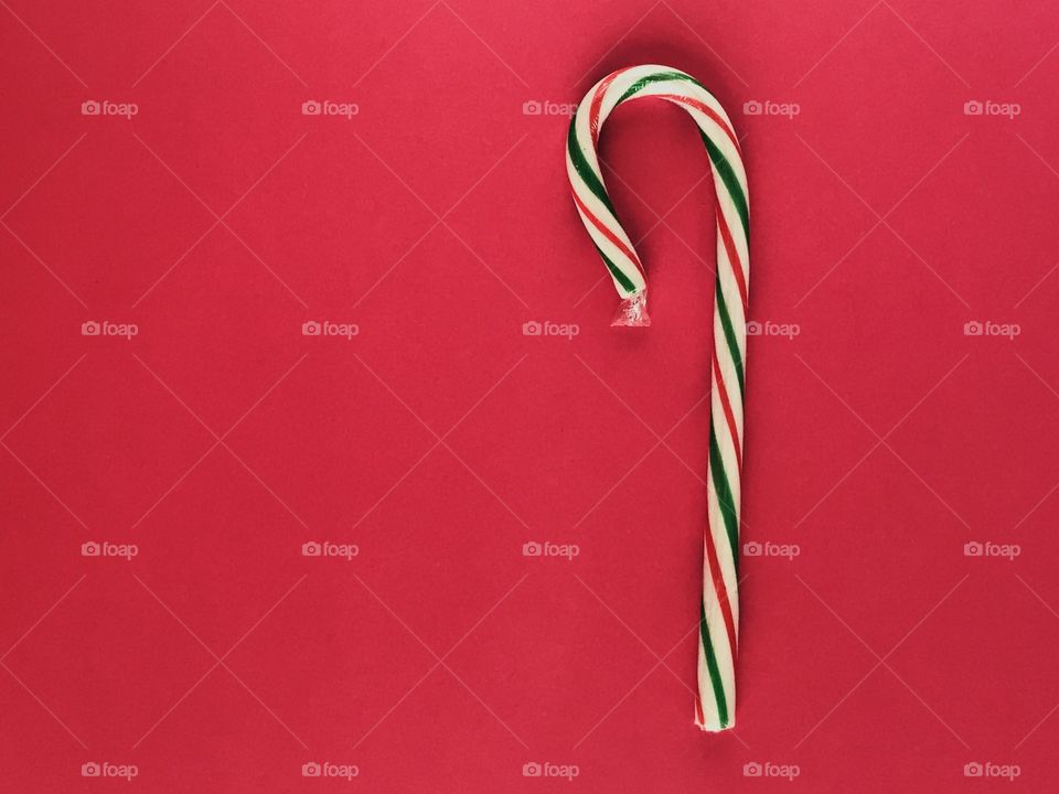 A candy cane on a red background 