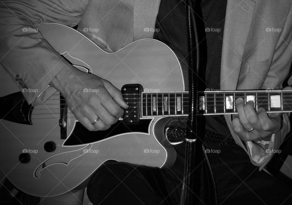 Guitar Hands. The hands of a skilled musician make a beautiful guitar come alive during a jazz gig. 
