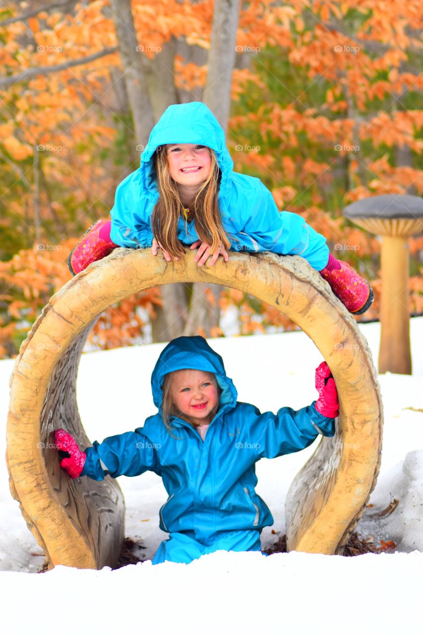 girls playing in rain gear