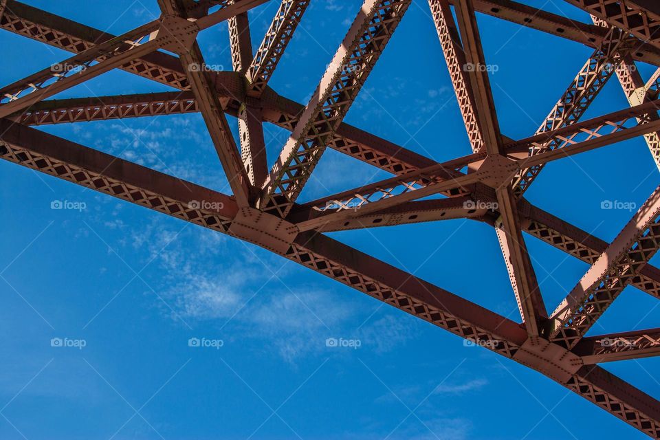 Geometric trellis on the underside of the Golden Gate Bridge in San Francisco, forming an almost abstract triangular pattern 