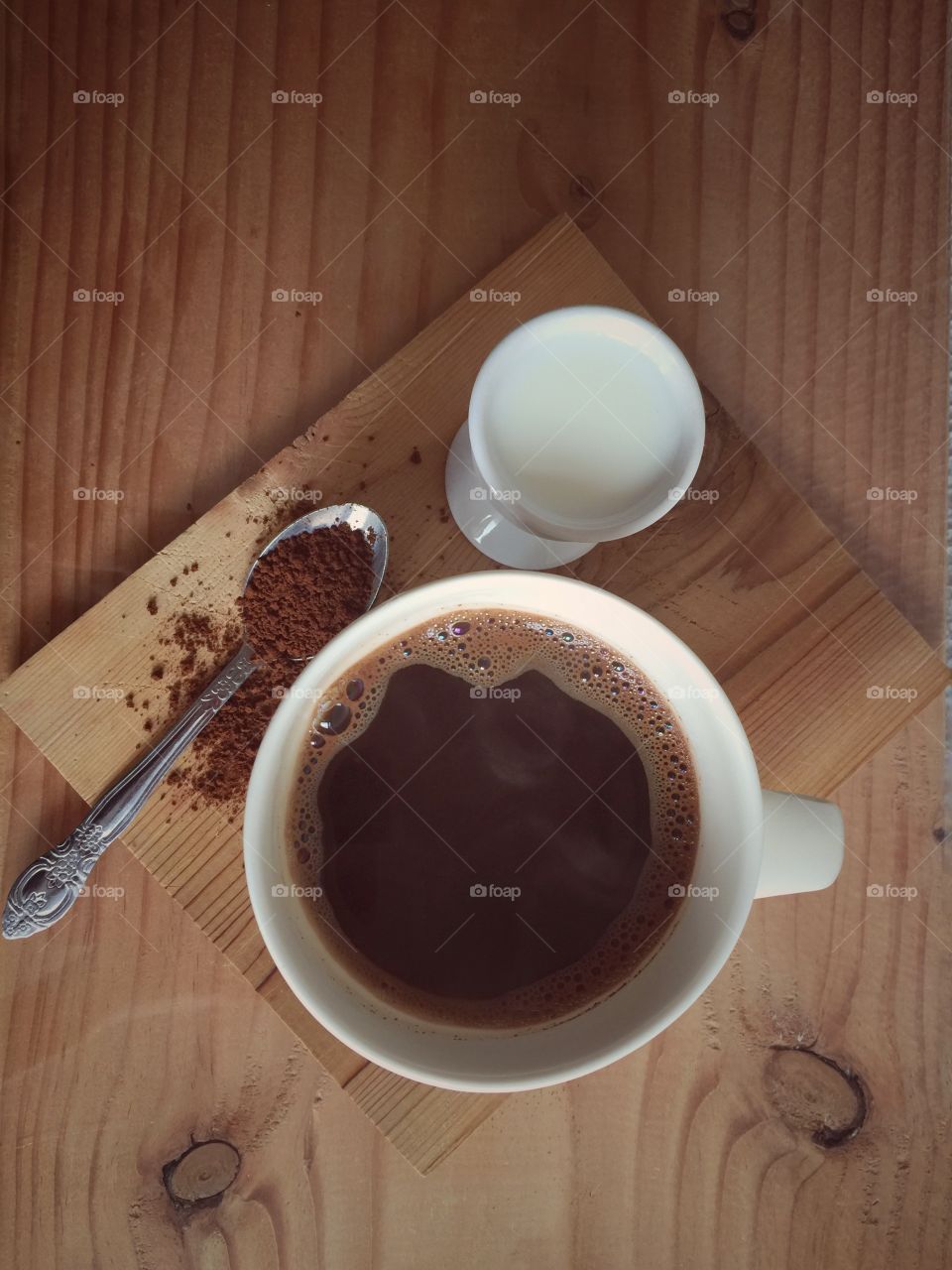 Overhead view of coffee cup and milk