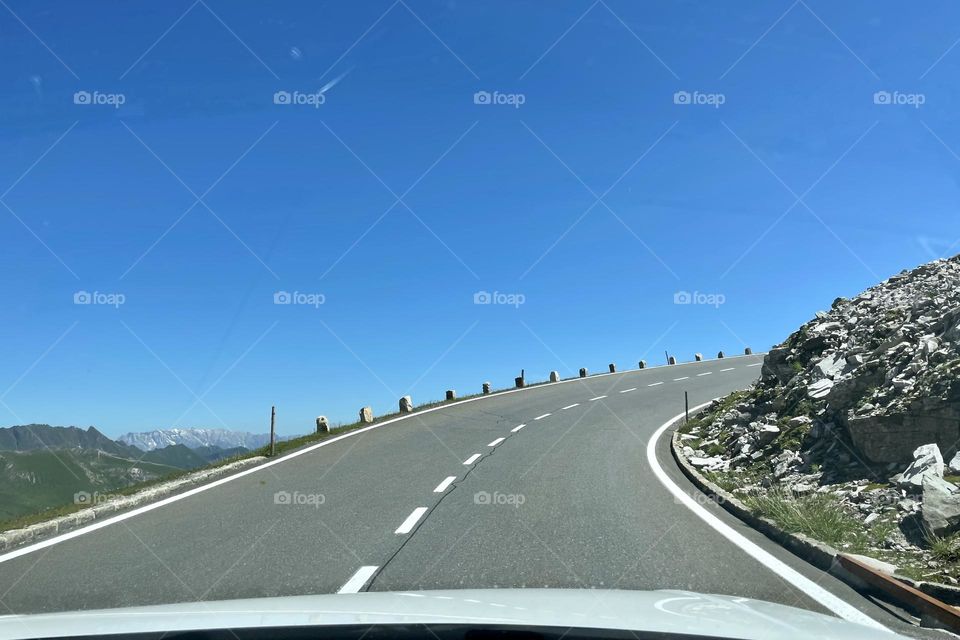 Road trip on Großglockner high alpine road  in the alps of Austria on a sunny summer day, view of mountains and road