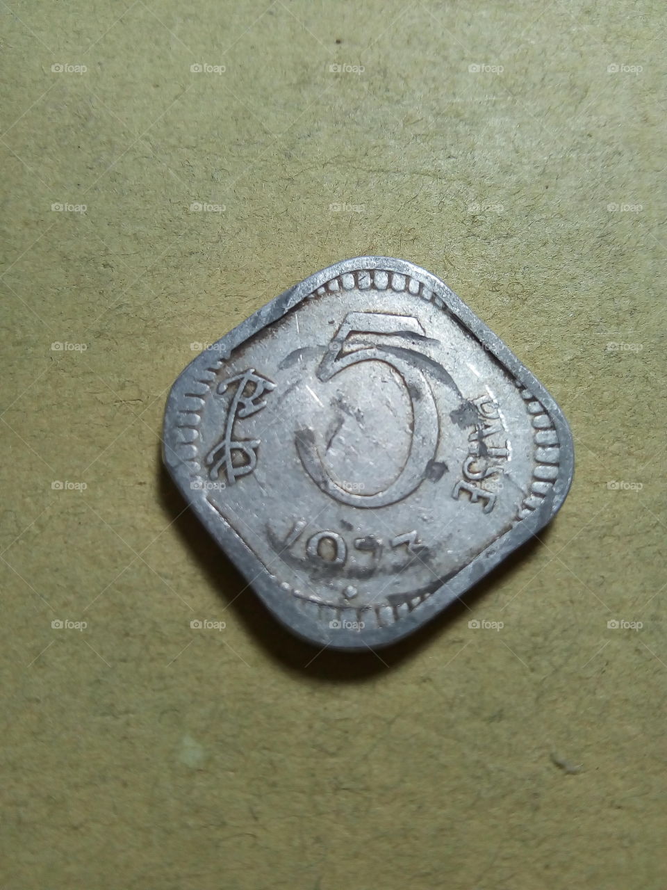 A coin of five paise- 1/20 share of Indian Rupee issued by Government of India in 1973.