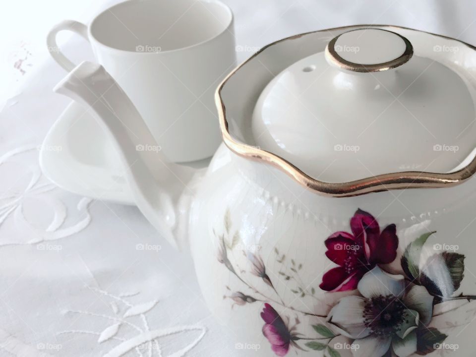 Tea Time Tea Time - white porcelain teapot with painted burgundy and white wild roses, white teacup, on white tablecloth