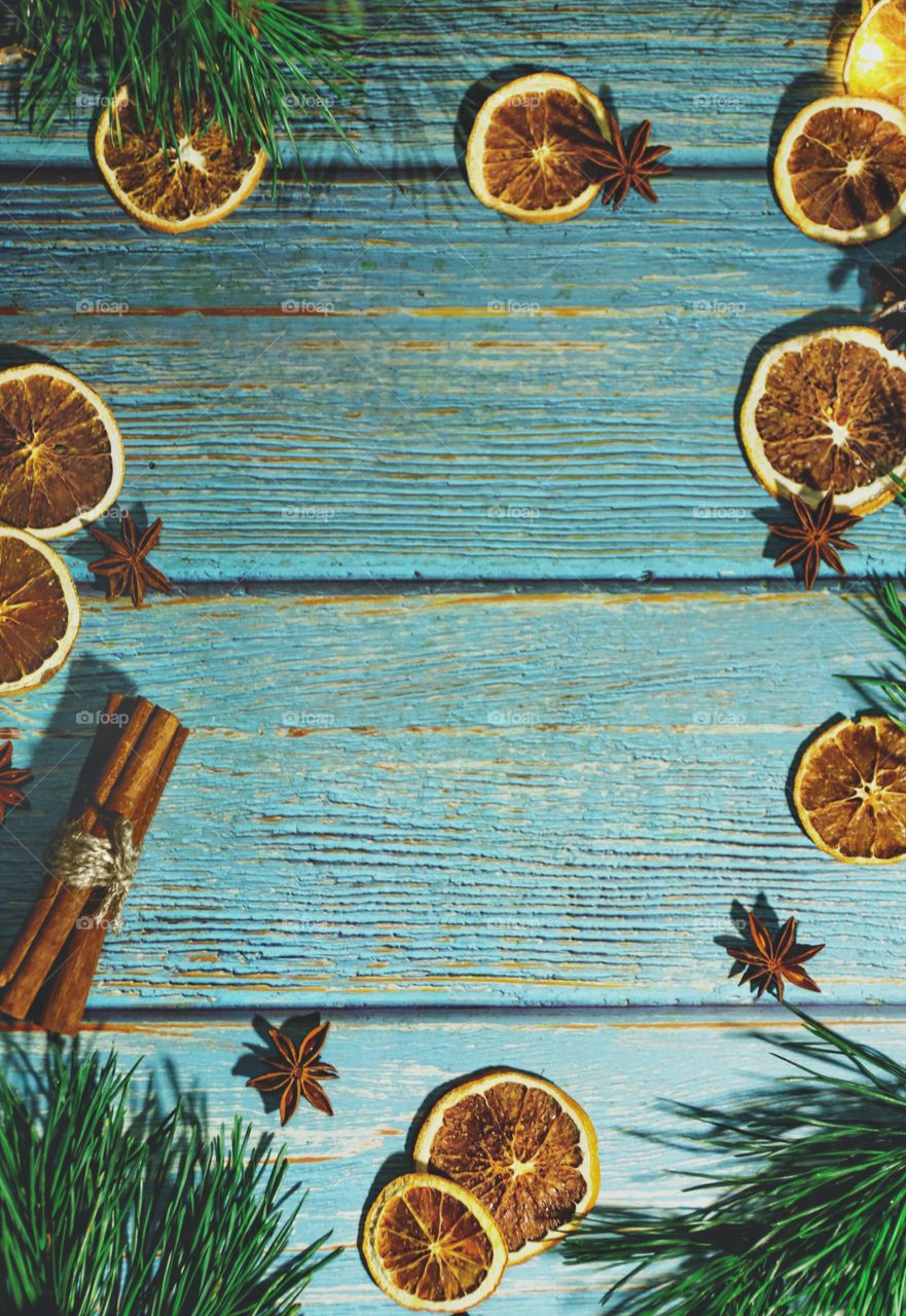 Christmas decorations for a card of dried oranges on a wooden table