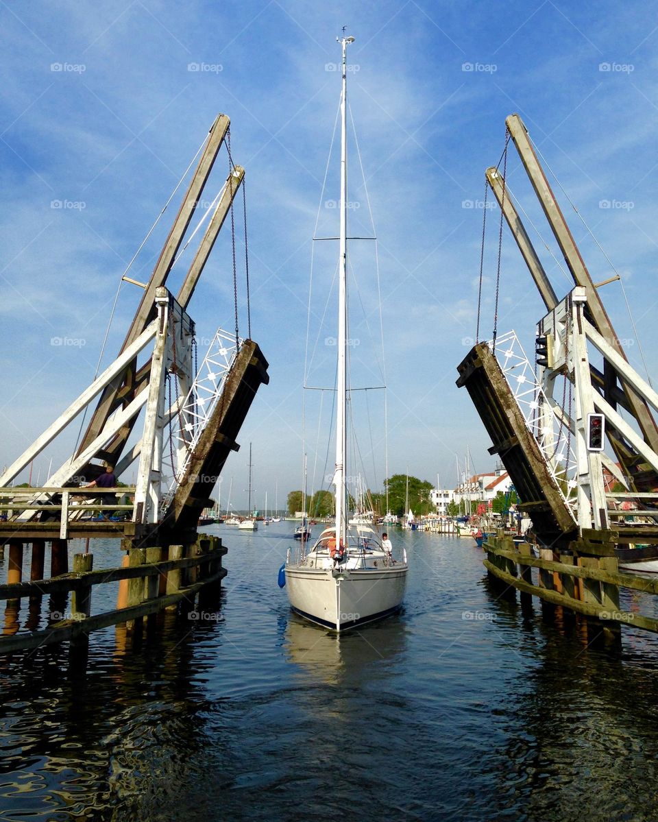 sailboat crossing a bridge on the river ricky in Greifswald, Germany