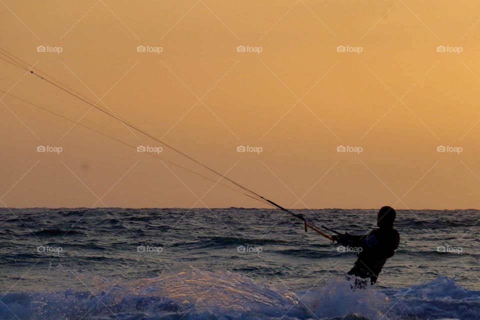 Kite surfer at sunset 