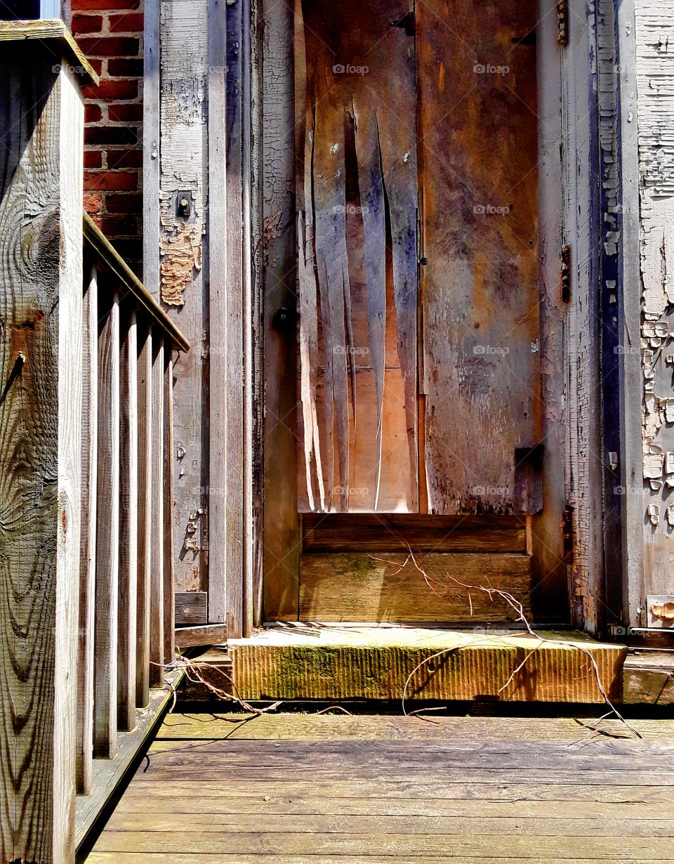 Abandoned house front steps and door