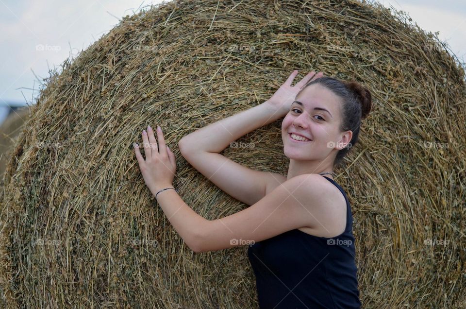 Portrait of Beautiful Young Girl on Straw Bale