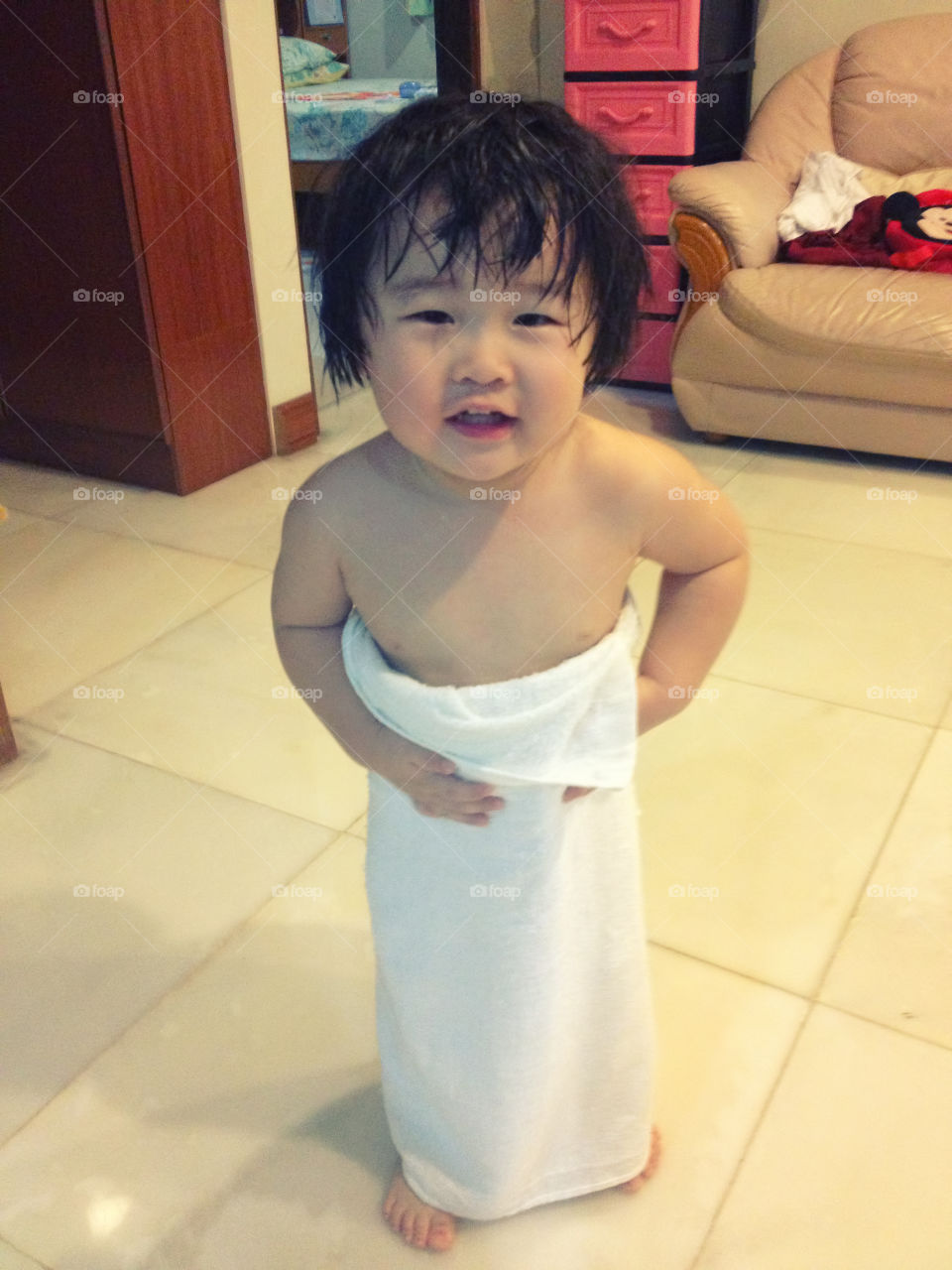 Little girl wrapped in towel after bath