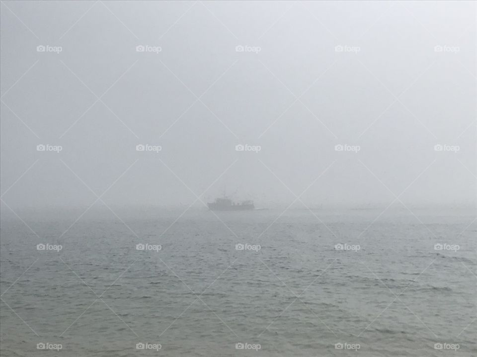 Foggy fishing boat