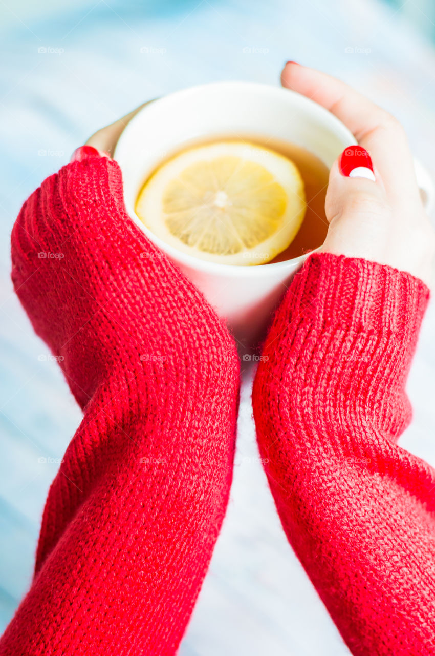 Woman holding lemon tea