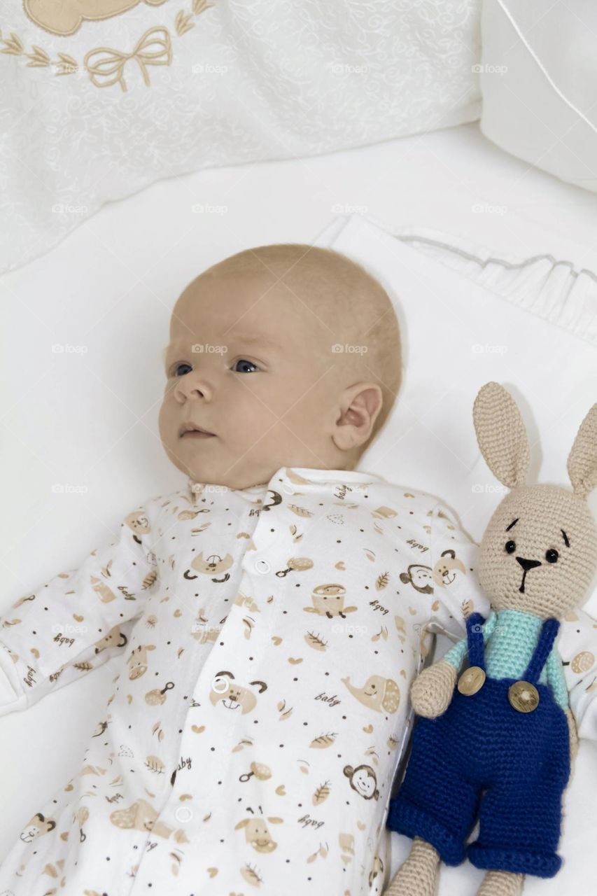 A newborn baby on a yellow and gray background. A photo shoot in the style of Newborn and lifestyle.