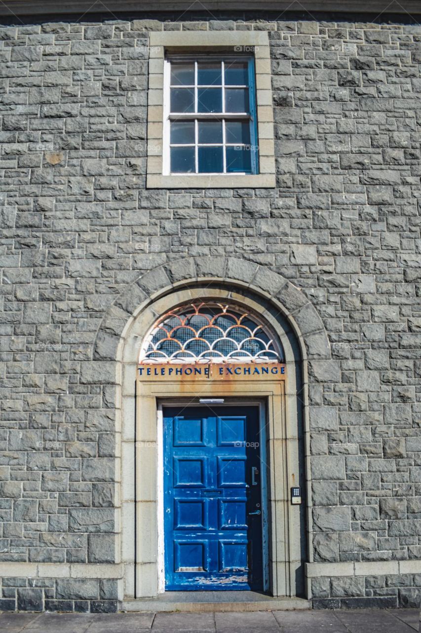 Old stone building with blue door