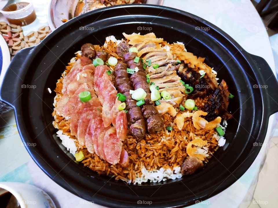 This delightful dish from Southern China is called lap mei fan (臘味飯) or Chinese preserved meat claypot rice