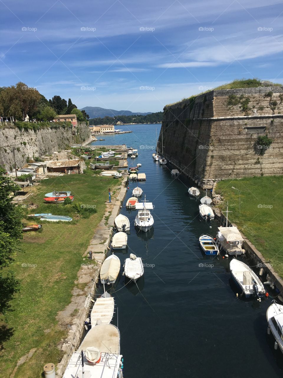 Boats moored behind Corfu Town Old Fortress, Greece