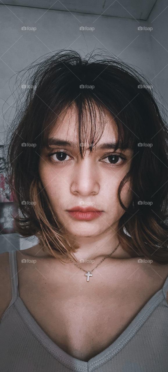 A girl with a sharp gaze looks into the camera