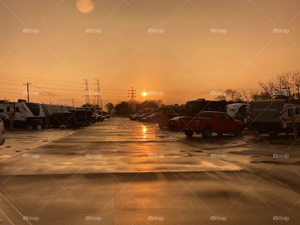 Unusual spot for a pic down Main Street in the RV Park. Distant Sun big and bright. Sunset Colours blending in the afternoon. 