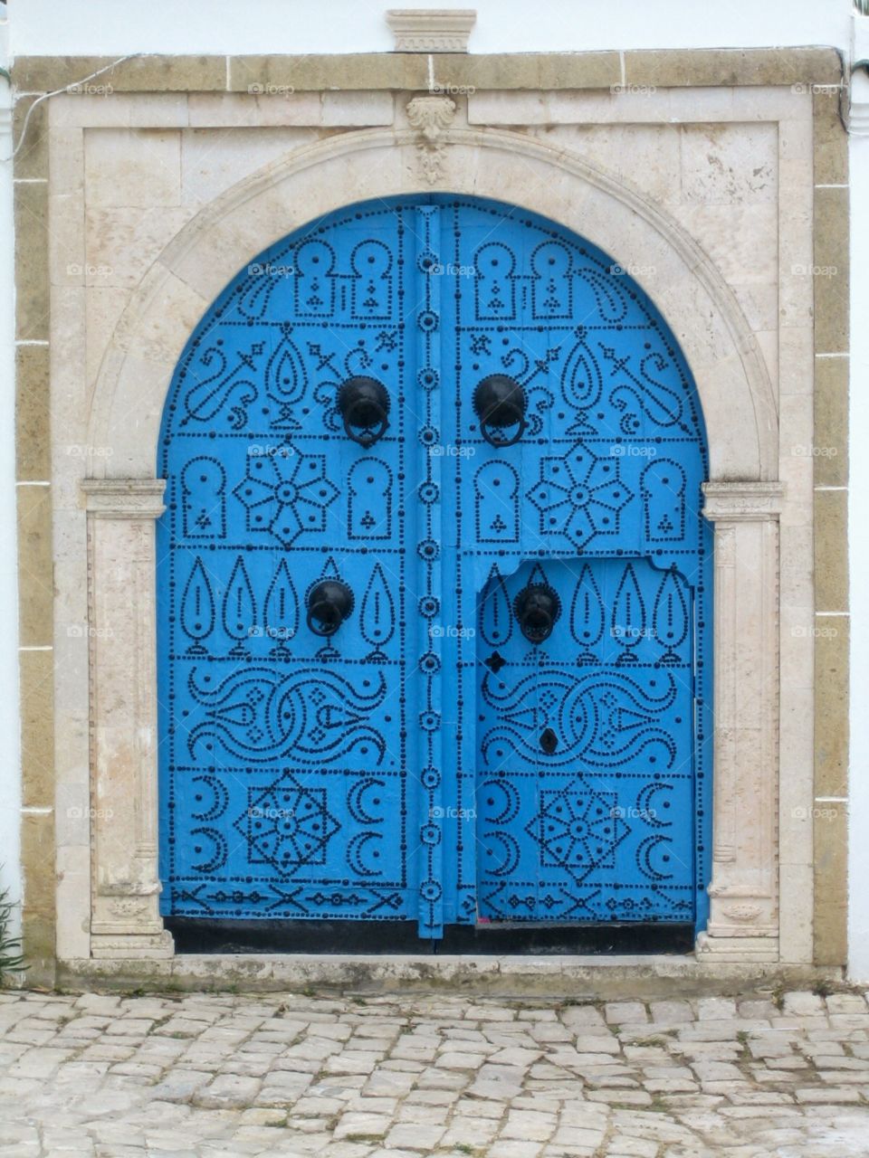 Blue door with oriental-looking ornaments