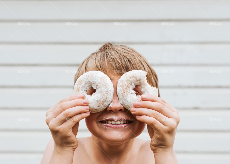 A boy with donut eyes. 