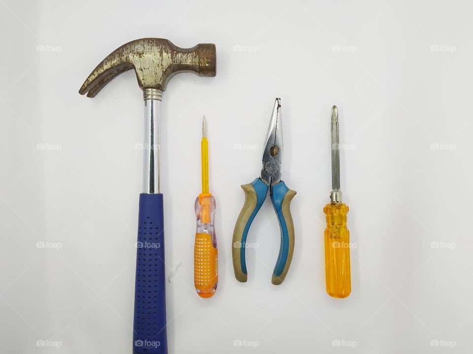 Hammer, screwdriver, pliers, testpen. Carpentry and workshop tools. Isolated on a white background
