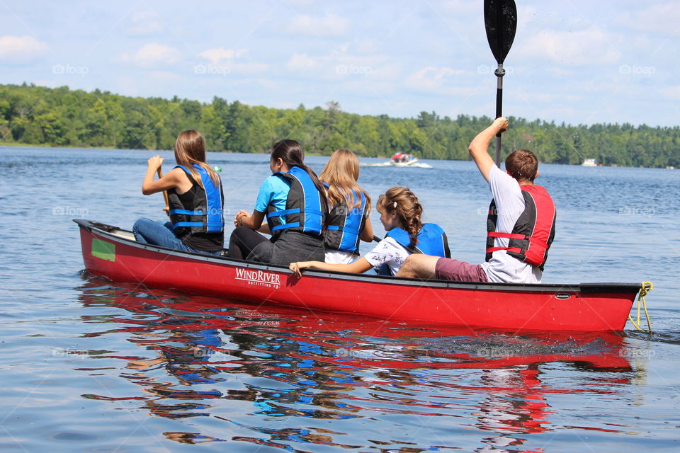 Teenagers on a canoe