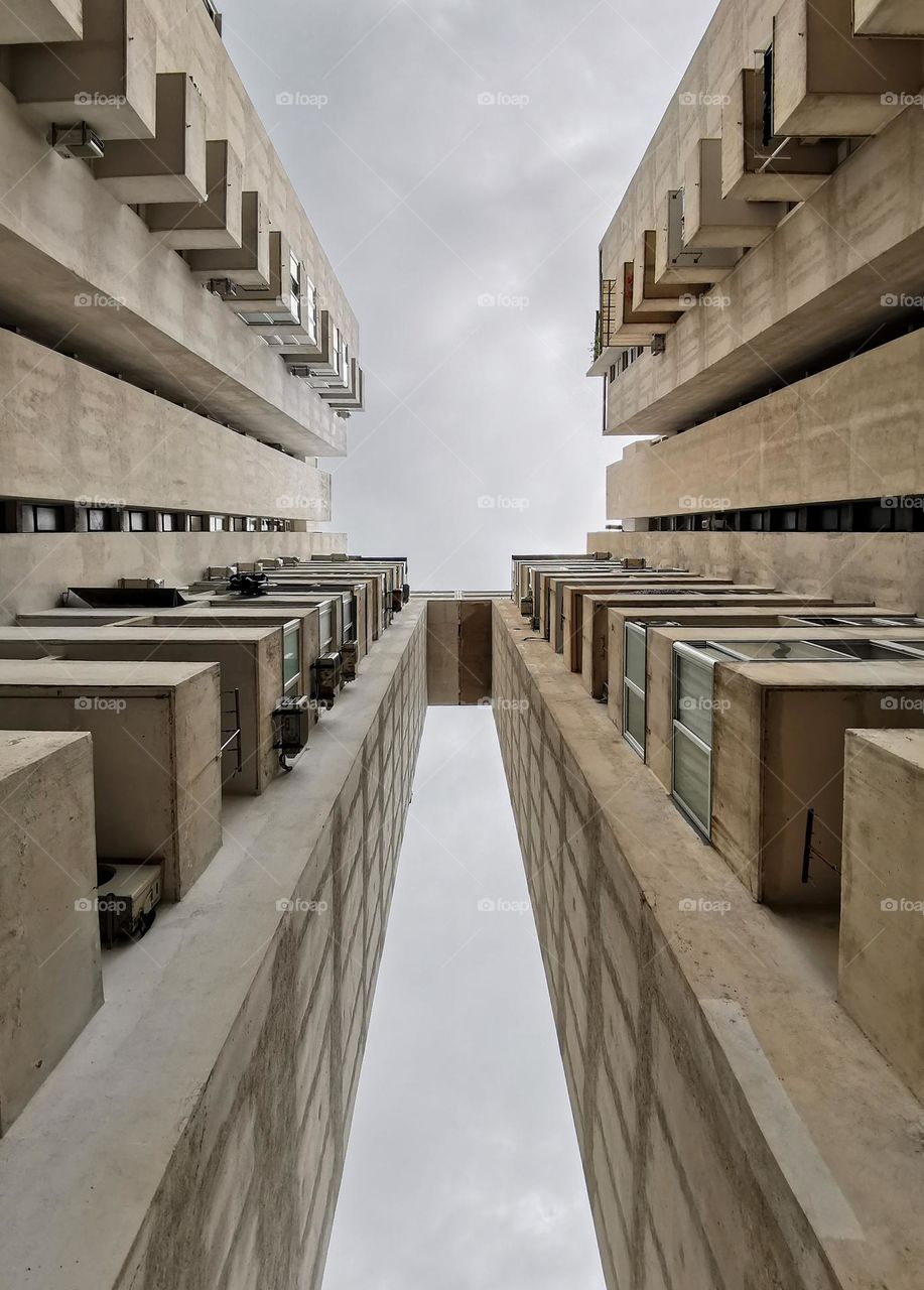 Low angle view of tall concrete residential block build during a brutalist period of architectural style in Split, Croatia