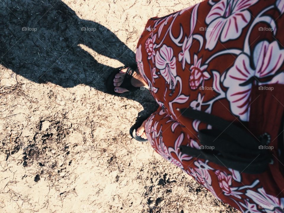 At the beach in Hawaiian shorts. 