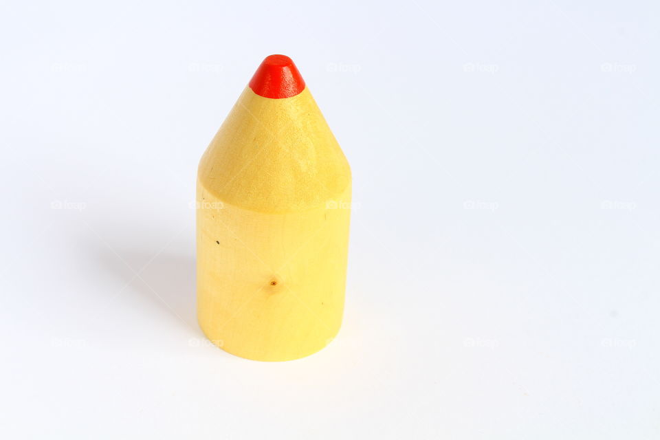 Miniature crayon cap from wood isolated macro shot