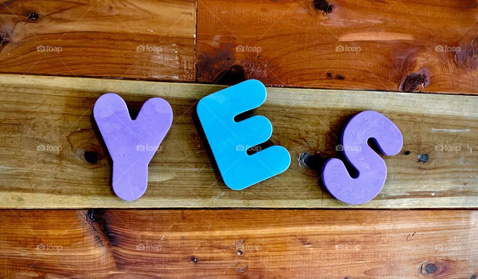 YES Word Kids Foam Letterings With Purple And Blue On Wooden Wall Displayed Close-Up